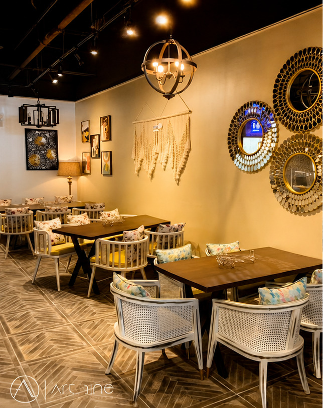Completed commercial dining interior with custom lighting, wall decor, and seating