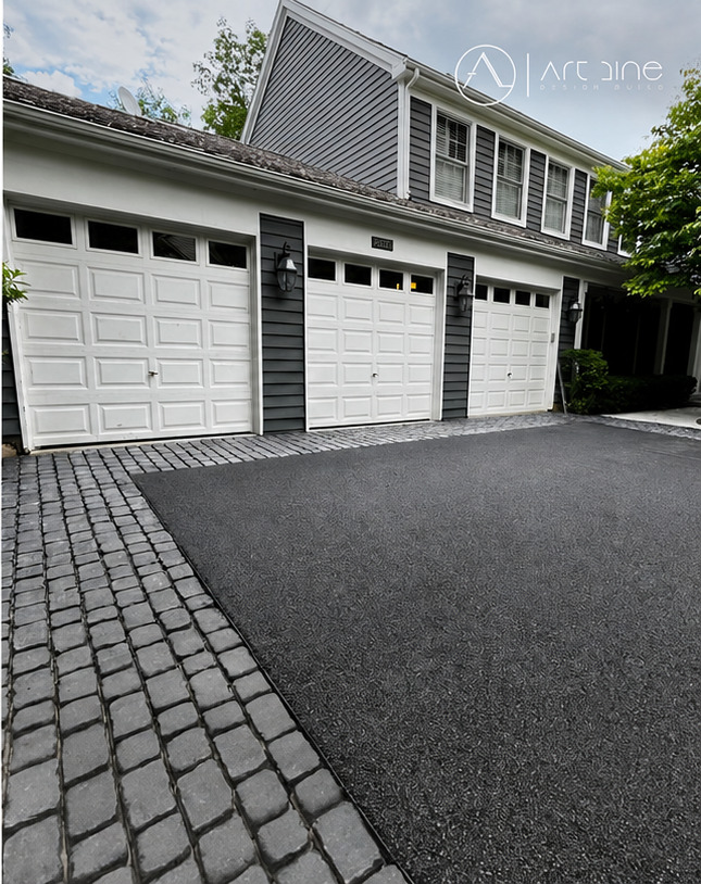Completed residential exterior driveway and garage approach with paved border detail
